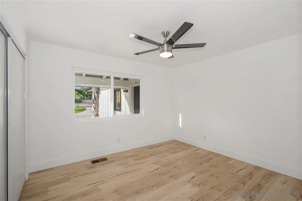 751 Crestview Road Vista, CA 92081 - Photo 17 of 24 a view of a big room with wooden floor and windows