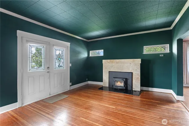 a view of empty room with wooden floor