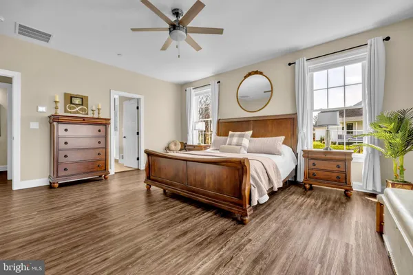 a bathroom with a sink a toilet a mirror a vanity and shower