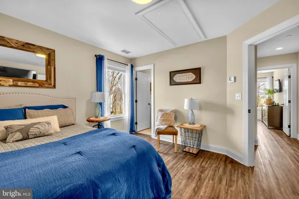 a view of a hallway with wooden floor and entryway