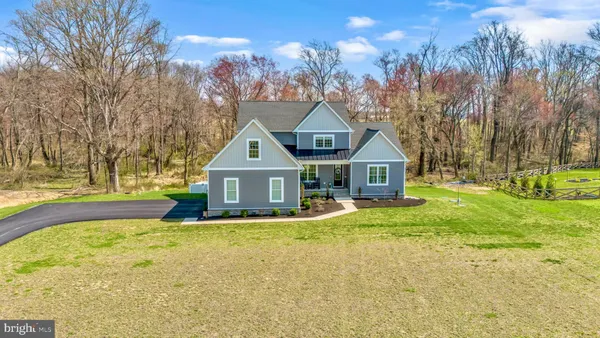 an aerial view of a house with a yard and trees