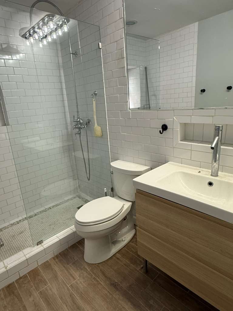 448 North Aberdeen Street, Unit 3 Chicago, IL 60642 - Photo 14 of 15 a bathroom with a sink toilet and shower