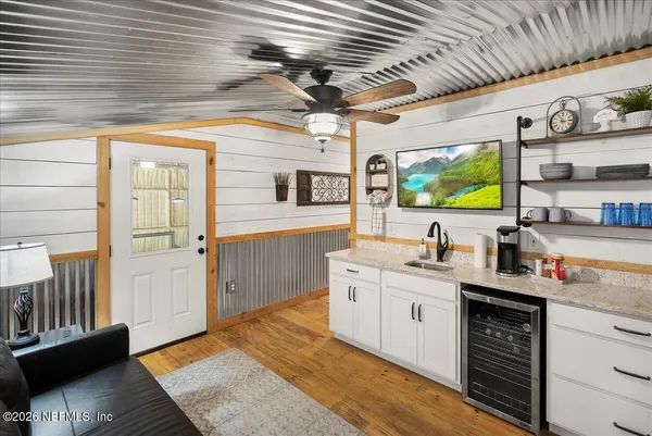 a living room with a couch dresser and a window