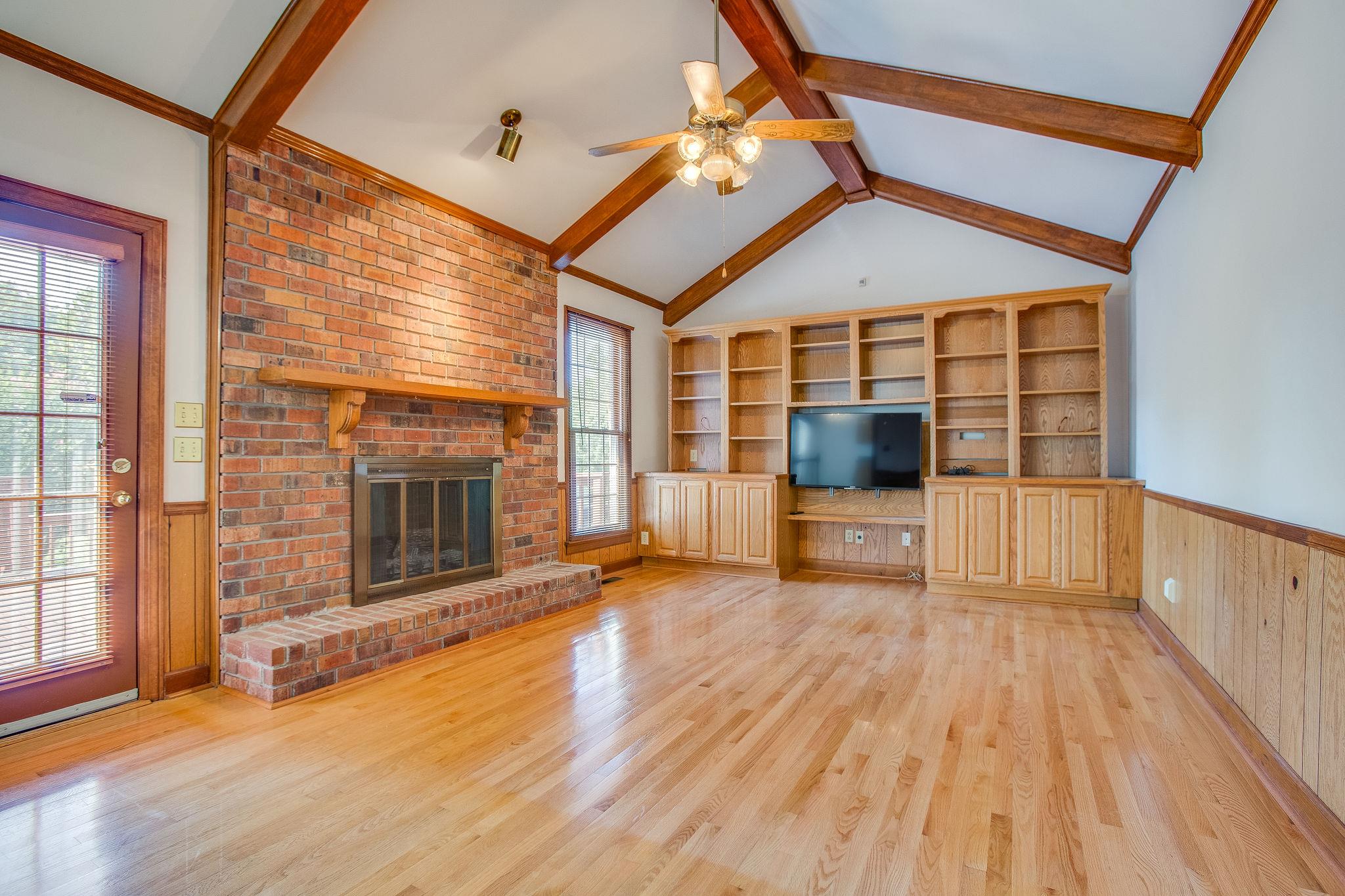 4047 Arno Road Franklin, TN 37064 - Photo 11 of 30 a view of a livingroom with wooden floor and a fireplace
