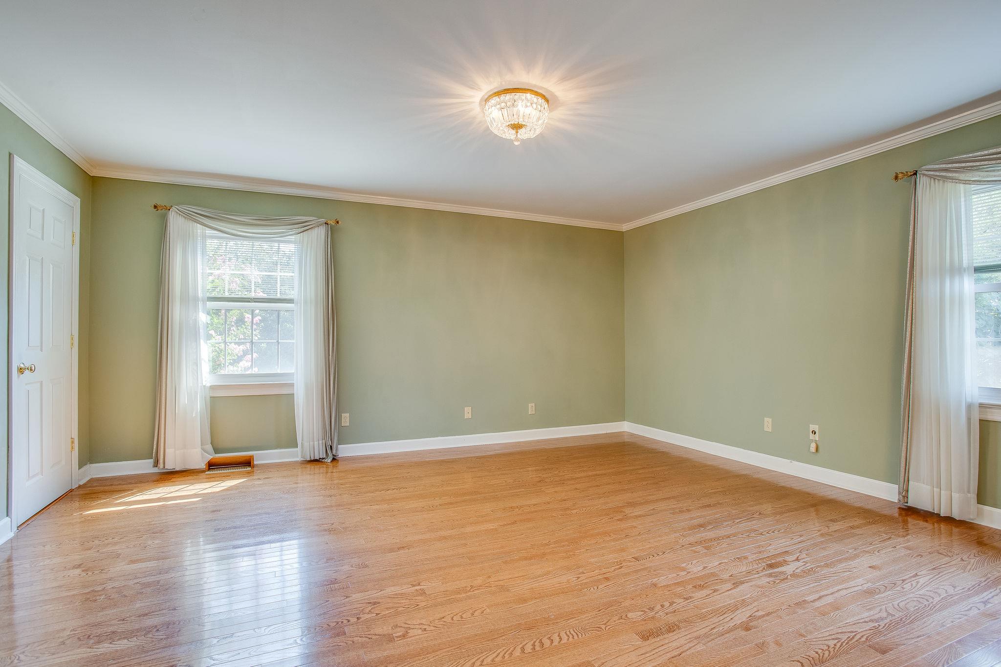 4047 Arno Road Franklin, TN 37064 - Photo 12 of 30 an empty room with wooden floor and windows