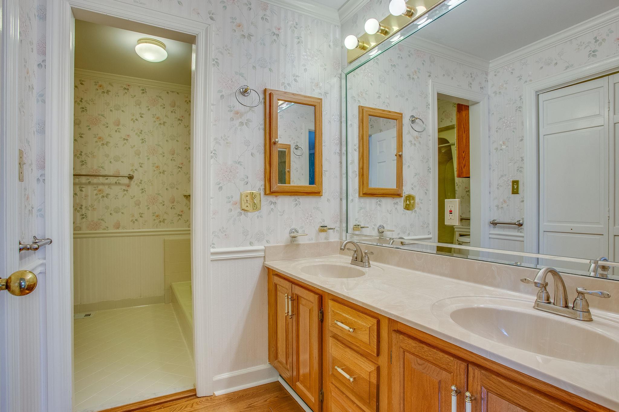 4047 Arno Road Franklin, TN 37064 - Photo 14 of 30 a bathroom with a double vanity sink a mirror and a shower