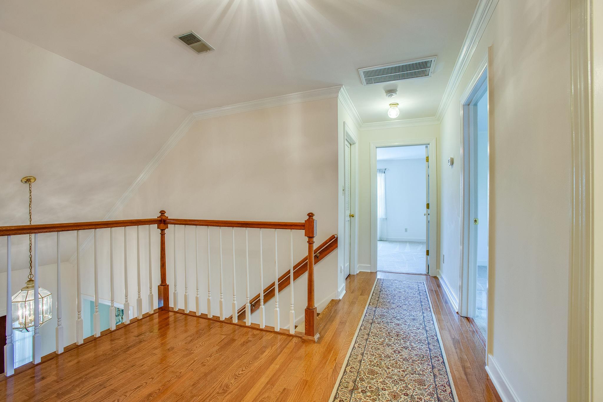 4047 Arno Road Franklin, TN 37064 - Photo 20 of 30 a view of a hallway with wooden floor and stairs