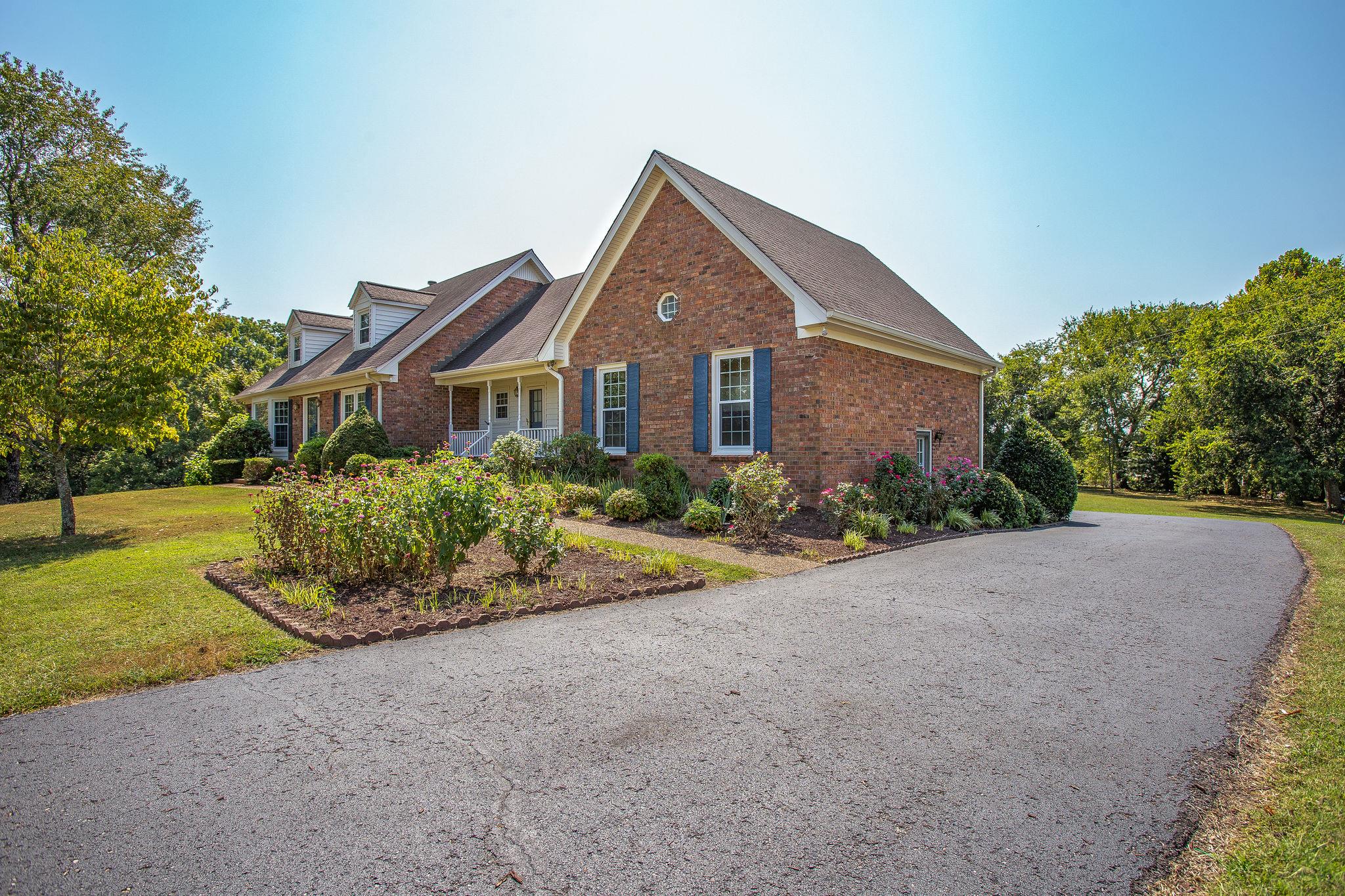 4047 Arno Road Franklin, TN 37064 - Photo 4 of 30 a front view of a house with a yard and garage