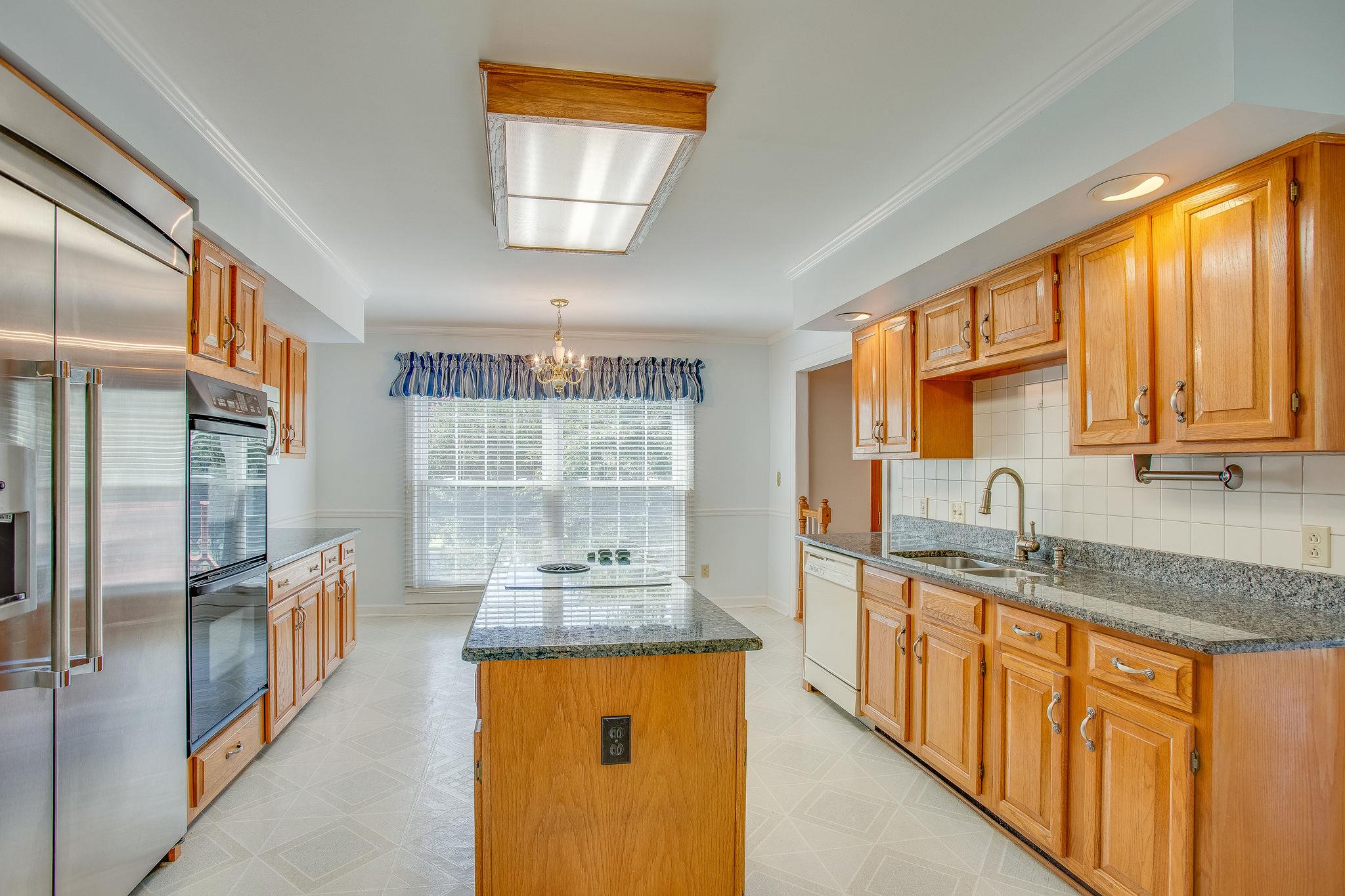 4047 Arno Road Franklin, TN 37064 - Photo 9 of 30 a kitchen with stainless steel appliances granite countertop a sink stove and refrigerator