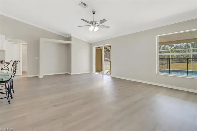 a view of a livingroom with a ceiling fan and window