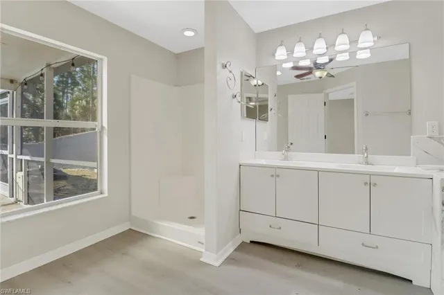 a bathroom with a sink vanity and mirror