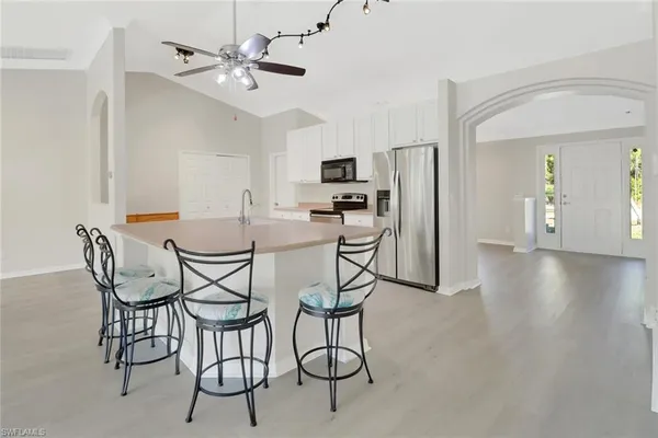 a dining room with furniture and wooden floor