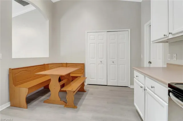 a spacious bedroom with a bed and a cabinets