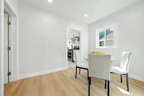 a bedroom with a bed and a lamp on dresser