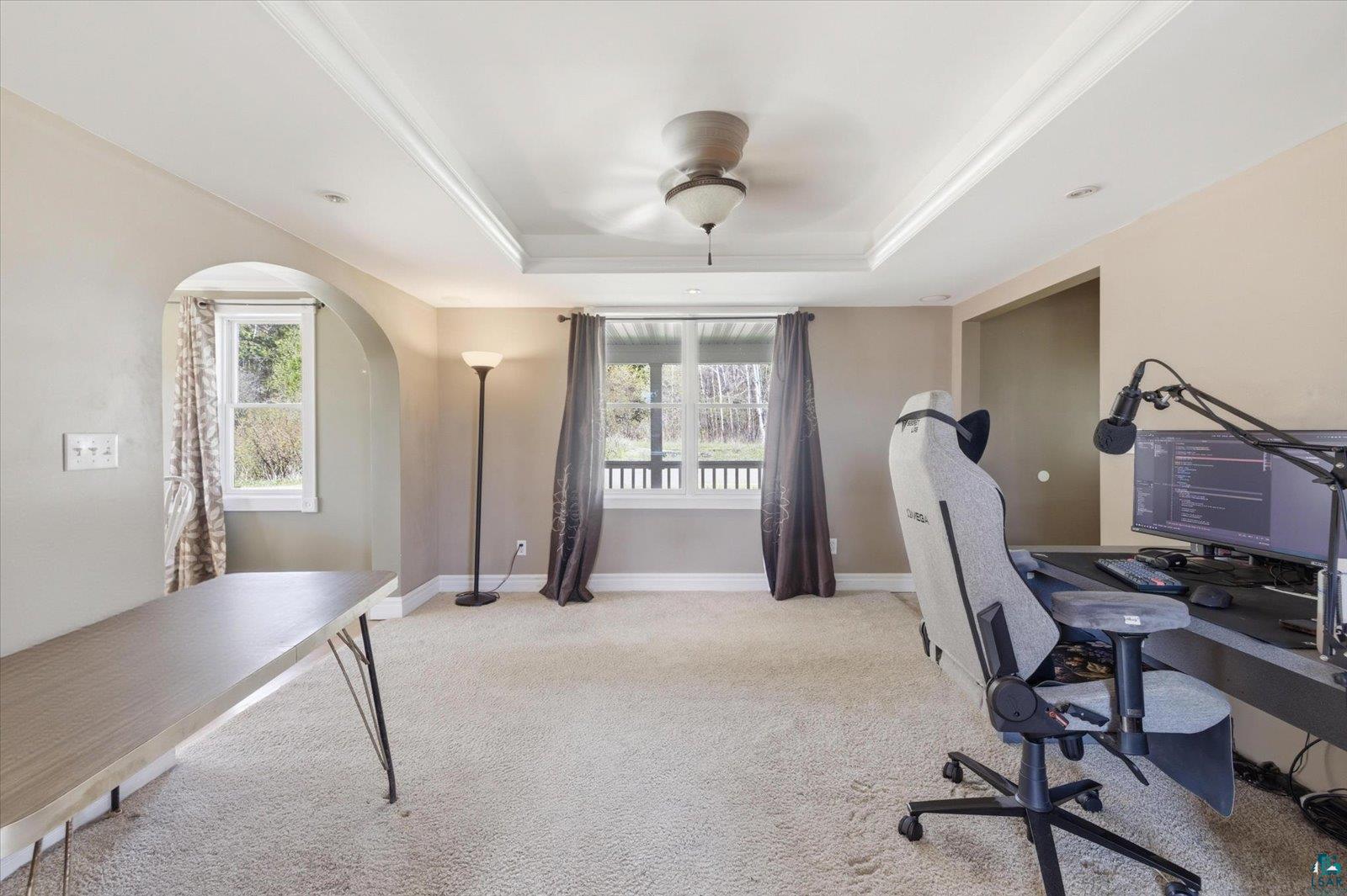 50 Main Street Soudan, MN 55782 - Photo 14 of 31 Recessed ceiling with crown molding and ceiling fan