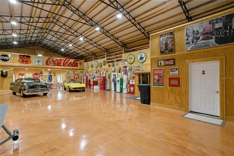 a kitchen with stainless steel appliances kitchen island granite countertop a table chairs and a stove