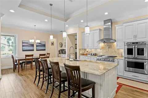 a living room with furniture a fireplace and a large window