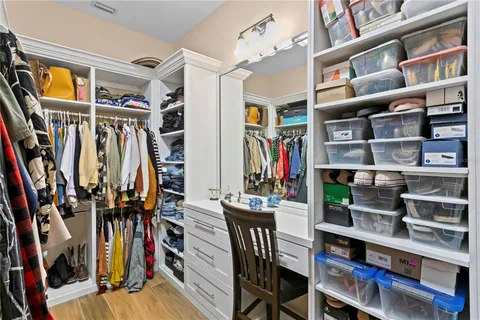 a bathroom with a granite countertop sink a toilet a mirror and shower