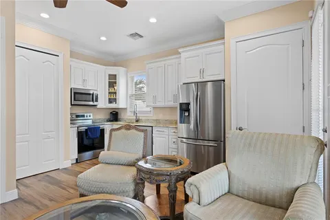 a view of house with a yard and potted plants