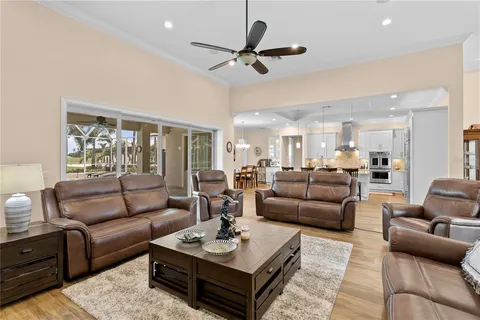a living room with a black white checkered floor with couches chair and a coffee table