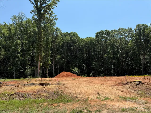 a view of white house with a yard