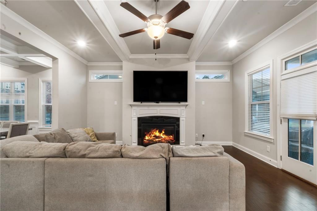 313 Senna Street Marietta, GA 30064 - Photo 11 of 43 a living room with furniture a fireplace and a flat screen tv
