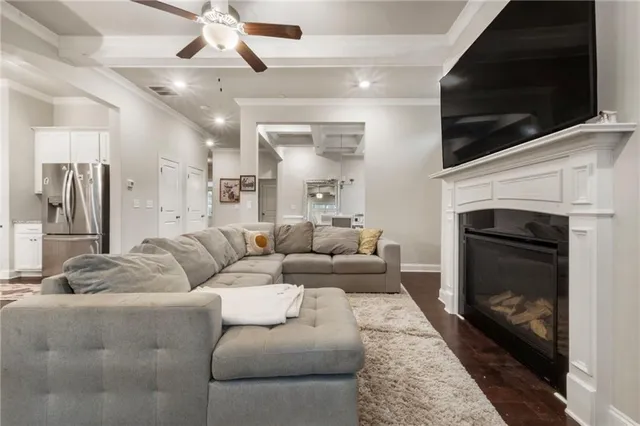 a living room with furniture and kitchen view
