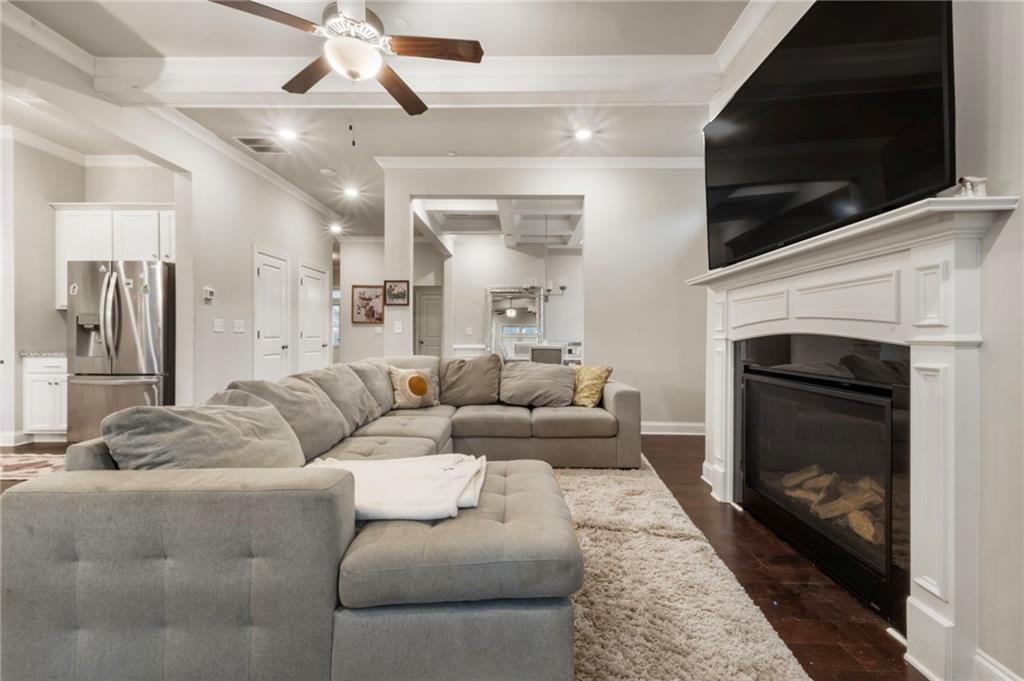 313 Senna Street Marietta, GA 30064 - Photo 12 of 43 a living room with furniture a flat screen tv and a fireplace