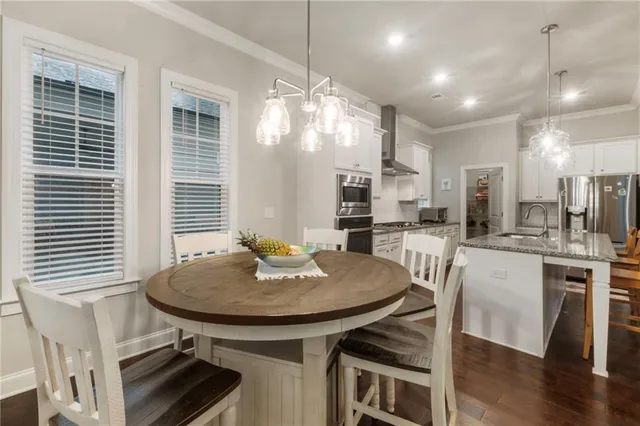 a view of a dining room with furniture windows and wooden floor