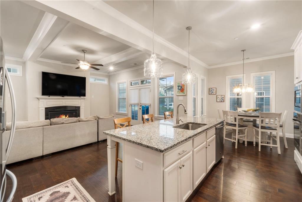 313 Senna Street Marietta, GA 30064 - Photo 18 of 43 a open kitchen with stainless steel appliances granite countertop a stove and a wooden floors
