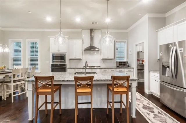 a kitchen with stainless steel appliances granite countertop a stove and a refrigerator