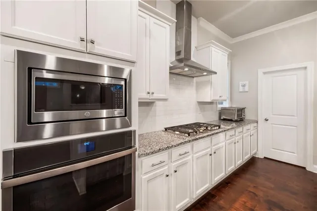 a utility room with stainless steel appliances and cabinets