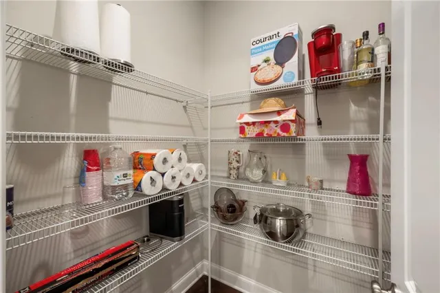 a bathroom with a granite countertop toilet a sink and a mirror