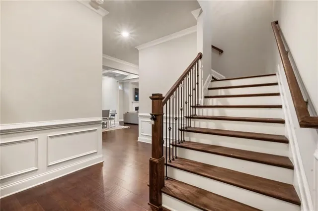 a view of a hallway with wooden floor and entryway