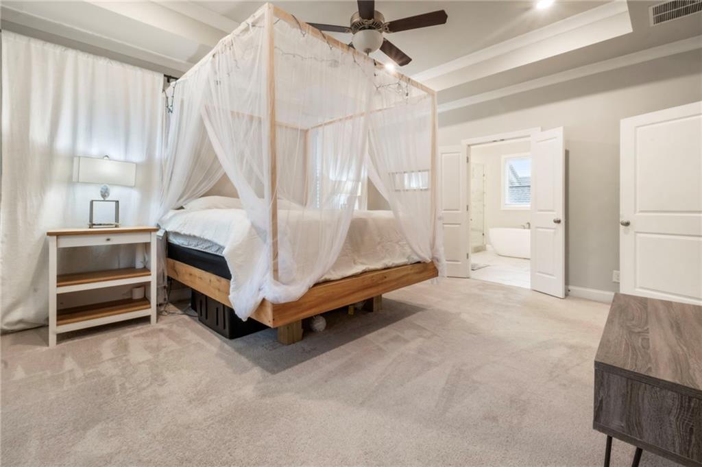 313 Senna Street Marietta, GA 30064 - Photo 26 of 43 a spacious bedroom with a bed and a table