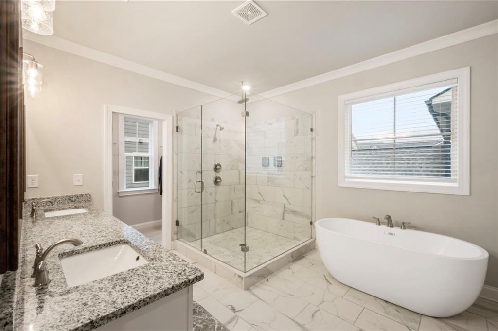 313 Senna Street Marietta, GA 30064 - Photo 29 of 43 a spacious bathroom with a granite countertop tub sink and glass door