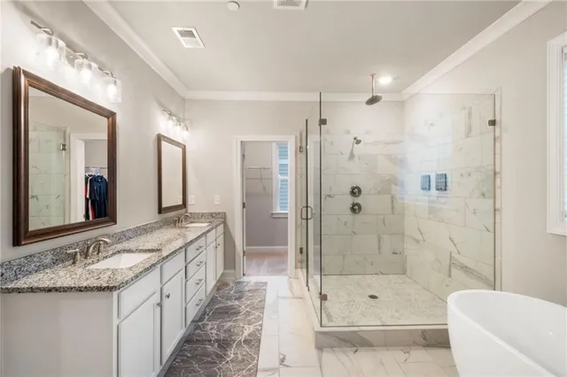 a white bath tub sitting next to a shower