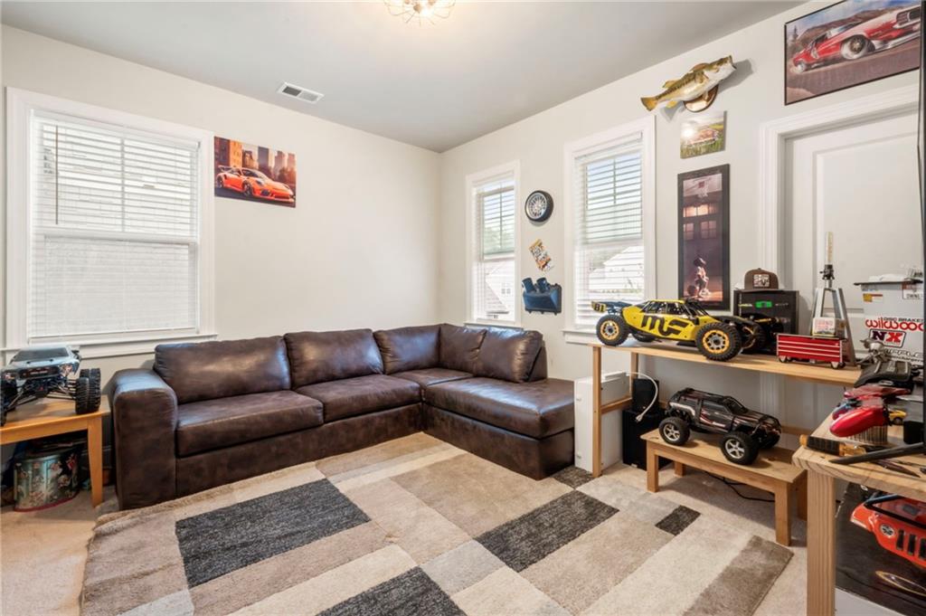 313 Senna Street Marietta, GA 30064 - Photo 35 of 43 a living room with furniture a rug and a window