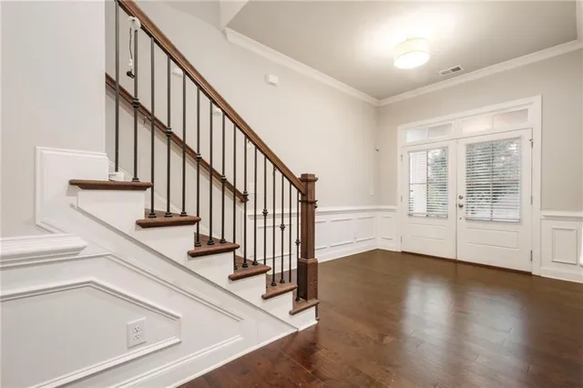 a dining room with wooden floor and a glass door
