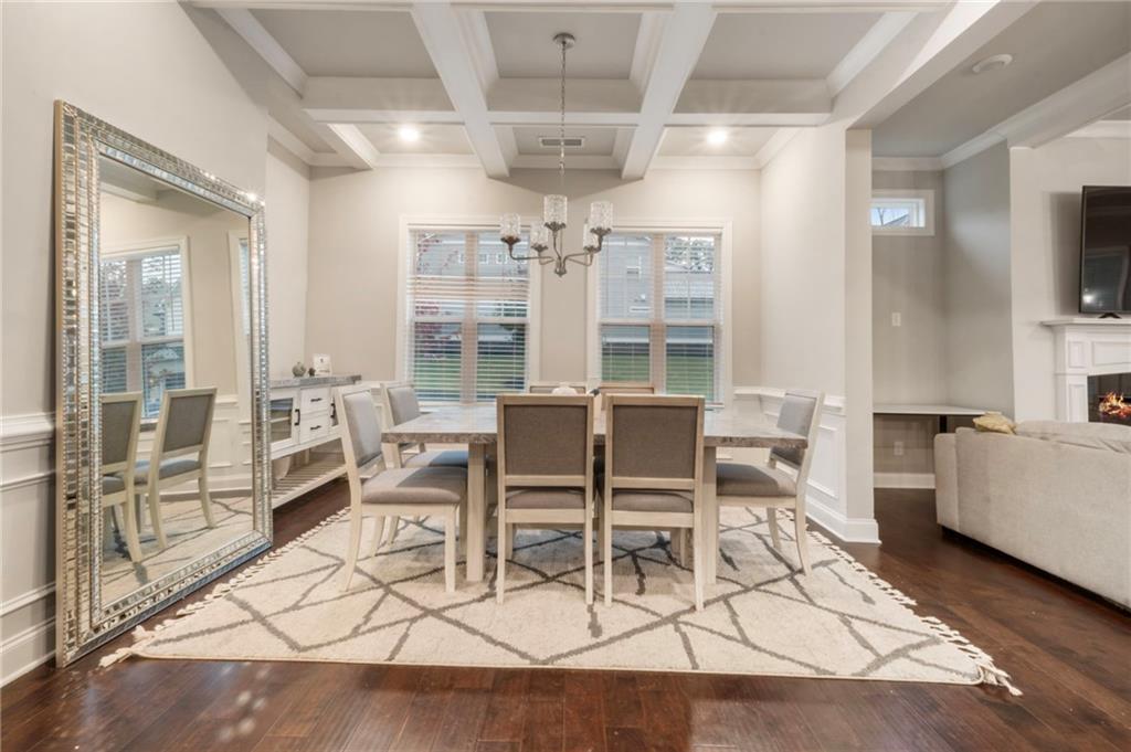 313 Senna Street Marietta, GA 30064 - Photo 8 of 43 a view of a dining room with furniture a chandelier and wooden floor