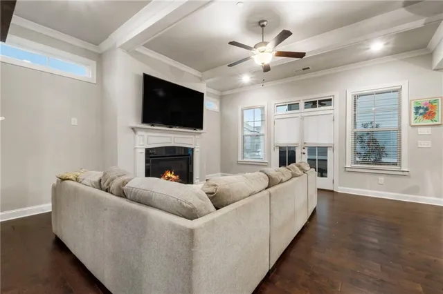 a living room with furniture a fireplace and a flat screen tv