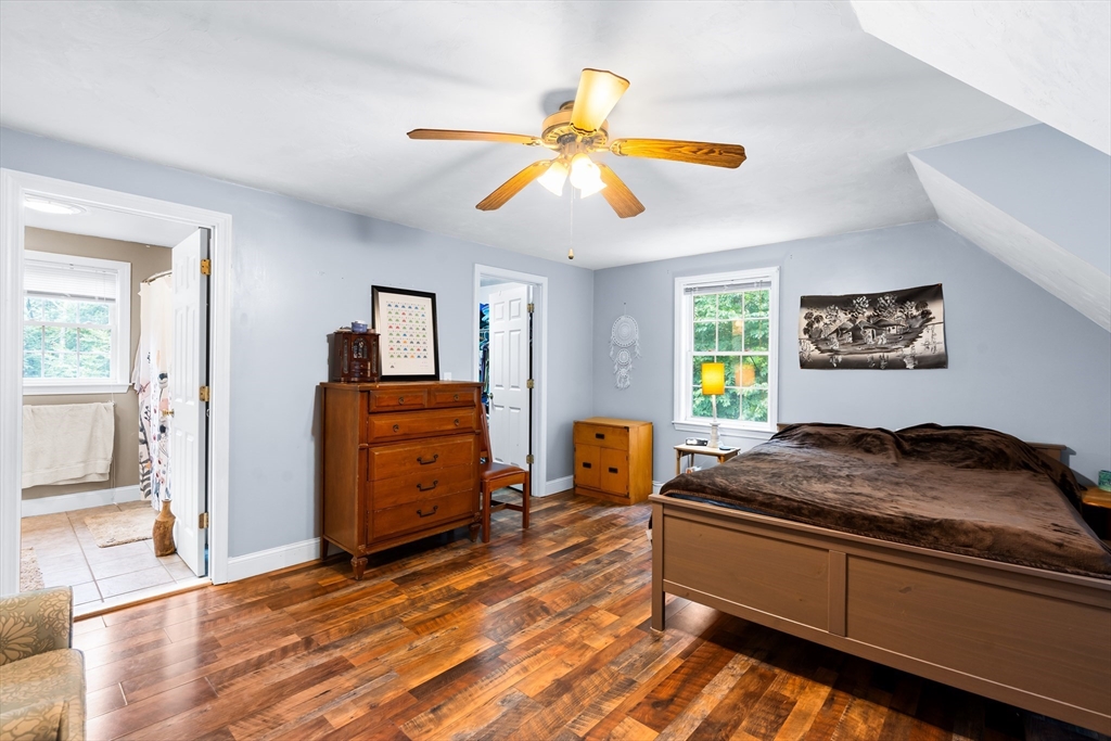 28 Birch Drive Petersham, MA 01366 - Photo 17 of 42 a bedroom with a bed and a chandelier