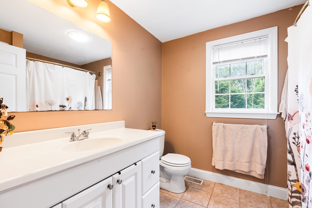 28 Birch Drive Petersham, MA 01366 - Photo 18 of 42 a bathroom with a sink a toilet and a window