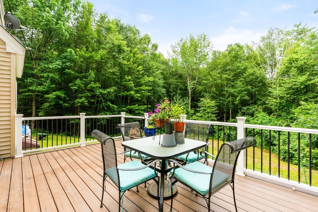 28 Birch Drive Petersham, MA 01366 - Photo 27 of 42 a balcony with wooden floor table and chairs