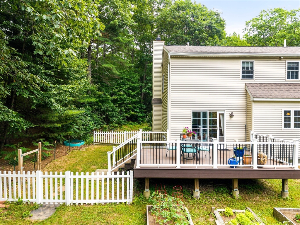 28 Birch Drive Petersham, MA 01366 - Photo 32 of 42 a view of a house with a wooden deck and a floor to ceiling window