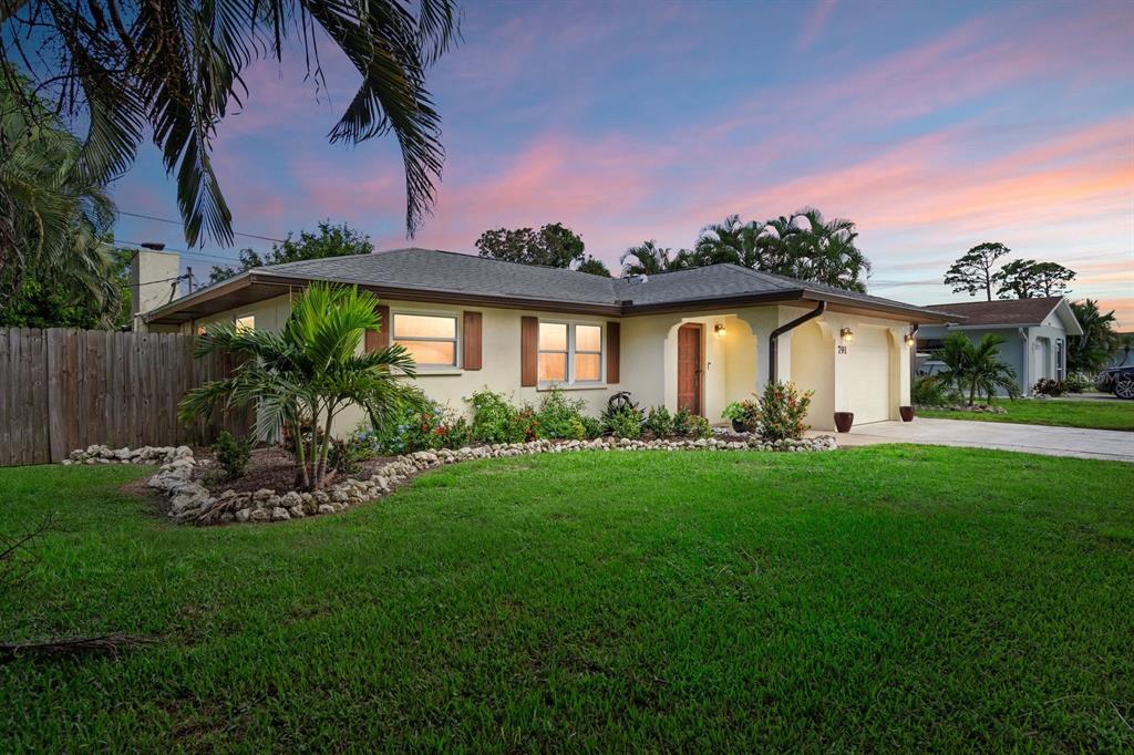791 Mohawk Road Venice, FL 34293 - Photo 1 of 1 a front view of a house with a garden and plants
