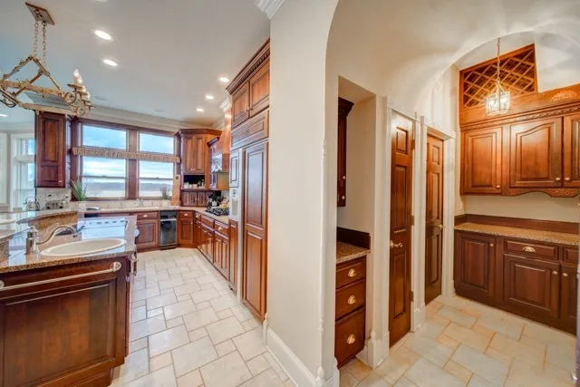 a kitchen with stainless steel appliances granite countertop a refrigerator and a sink