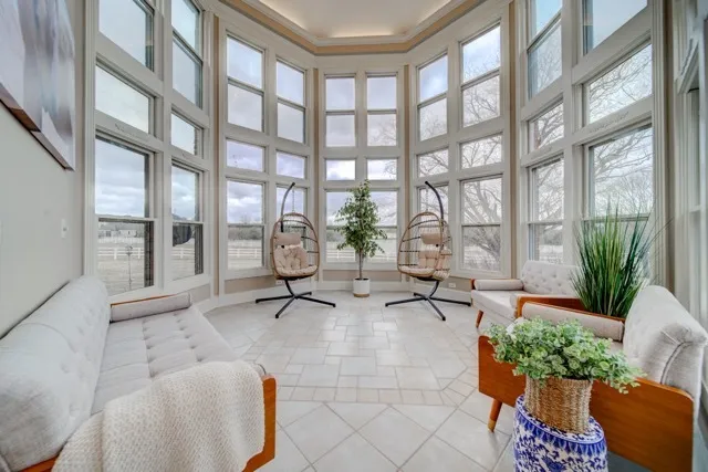 a living room filled with furniture and a large window
