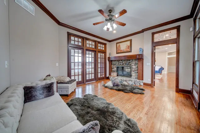 a spacious bedroom with a bed and glass windows