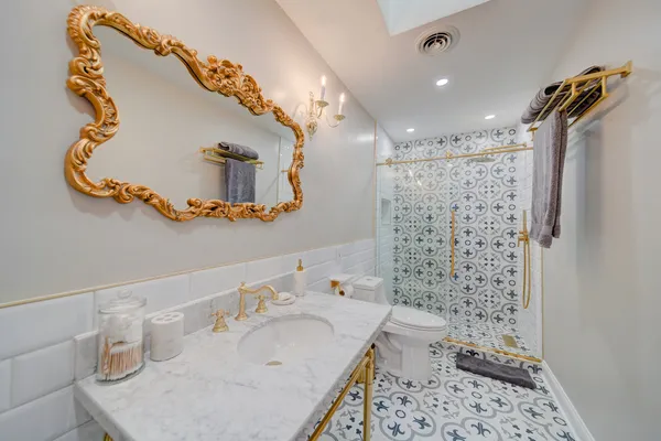 a bathroom with a sink toilet and shower